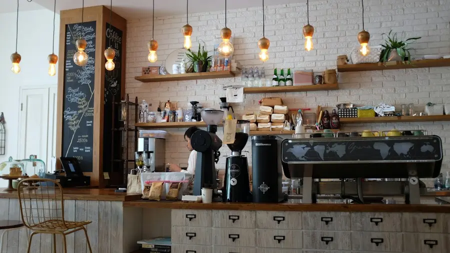 The counter, with the espresso machine and warm hanging bulbs